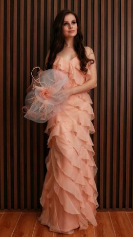 Woman wearing chiffon ruffled dress light peach colour