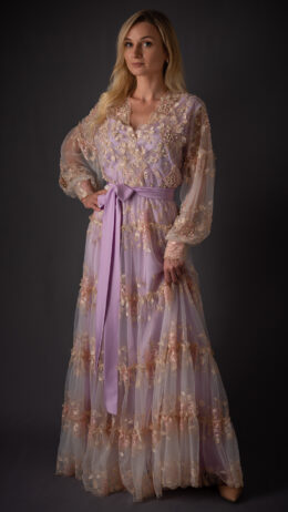 woman wearing long dantel dress purple color embellished with crystals and lulu