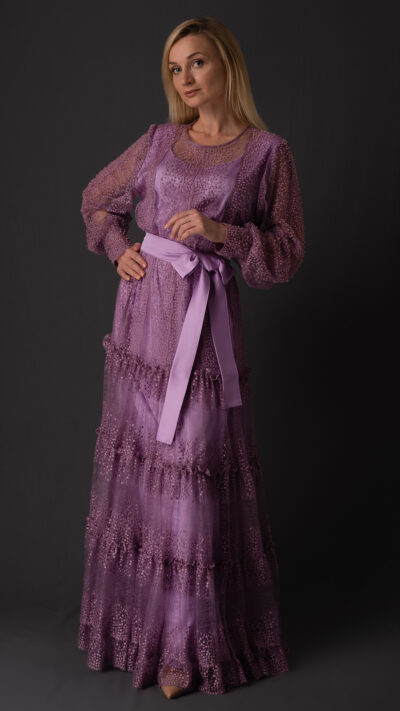 woman wearing long dress with sleeves purple colour made of lace fabric