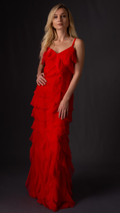 woman wearing red ruffled dress cut from chiffon