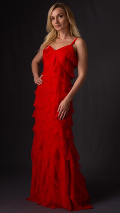 woman wearing red ruffled dress cut from chiffon