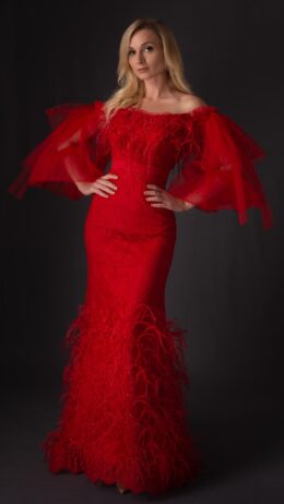 woman wearing red off shoulder dress decorated with feathers and crystals