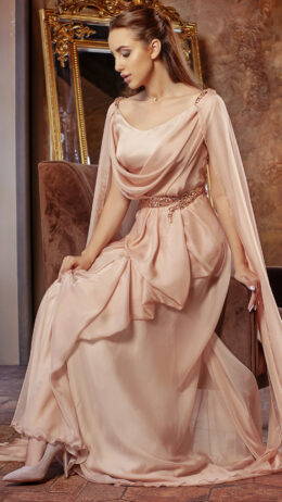 Woman wearing long chiffon dress beige colour