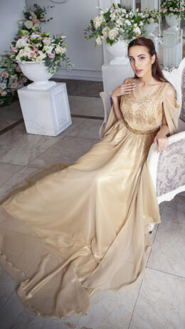 woman wearing evening gown golden colour with embroidered top and belt