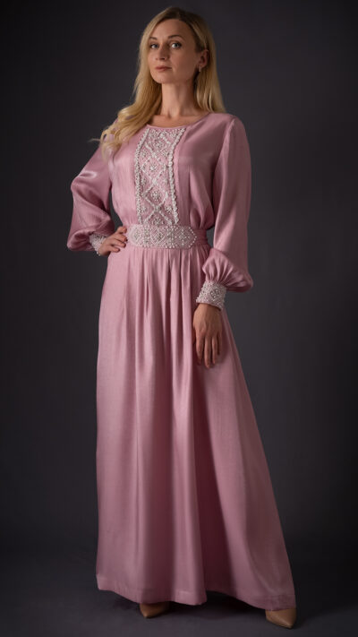 woman wearing pink kaftan style dress with embroidery