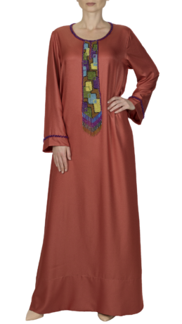 woman wearing orange embroidered jalabiya style dress