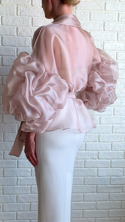 woman wearing light pink organza blouse view from the back