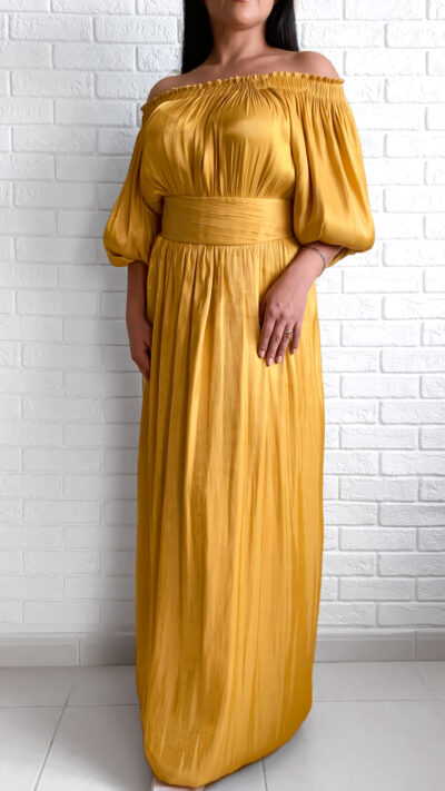 woman wearing off shoulder dress golden colour