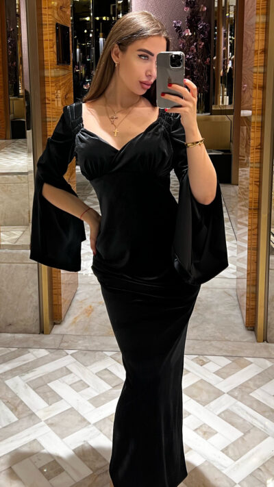 woman wearing long black velvet dress